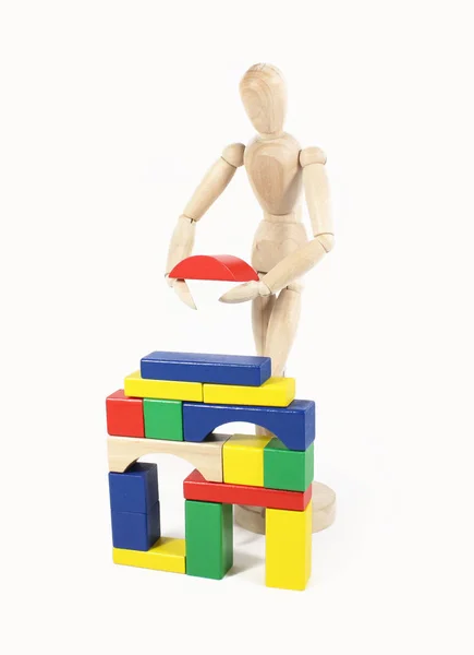 Wooden Doll Builds House Building Blocks — Φωτογραφία Αρχείου