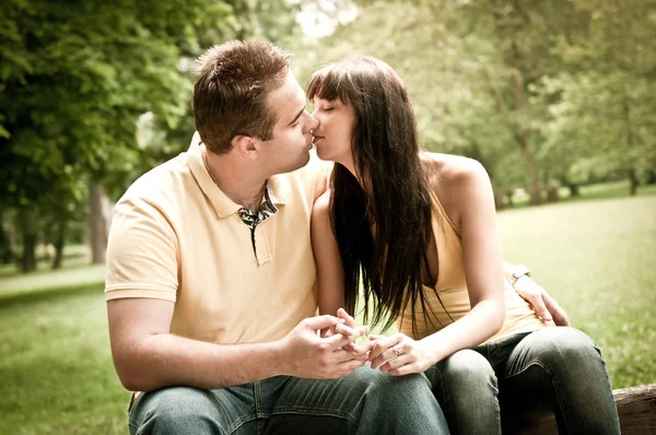 Young Couple Love Kissing Outdoors Sitting Bench Royalty Free Stock Photos