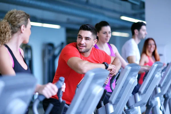 stock image group of people running in the gym