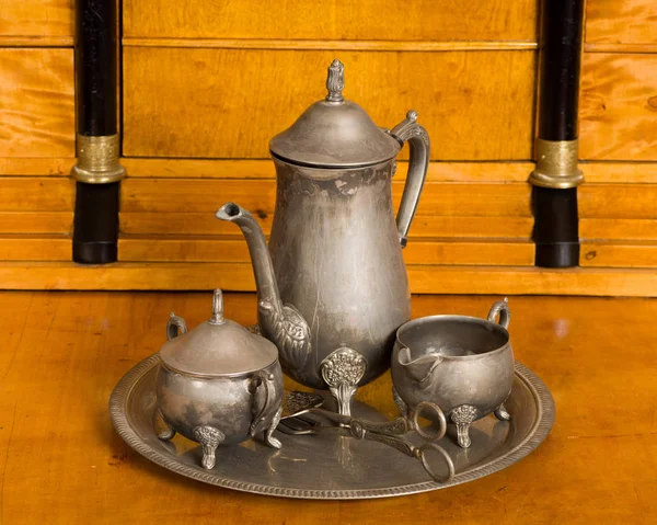 Antique tea service on an antique cherry wood desk