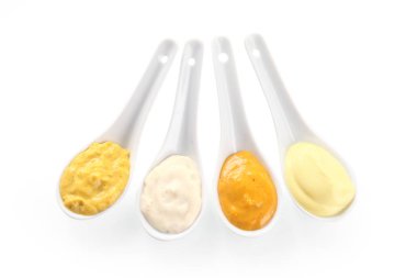 Close up Assorted Flavored Rub and Marinade Pastes on White Serving Spoons, Isolated on White Background. clipart