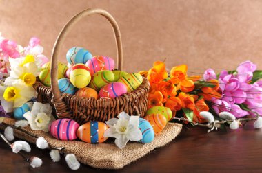 easter nest with many painted easter eggs,daffodils and pussy willow\n clipart