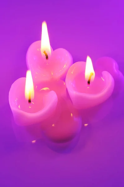 Three Melting Pink Candles Heart Shape Violet Light — Stockfoto