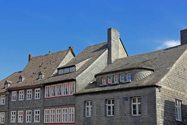 old houses with slate facade and slate roof on the marketplace in goslar