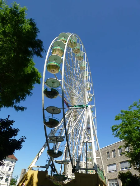the ferris wheel is a wheeled folk festival ride that lifts passengers along its perimeter to a position with good views. as a stationary attraction,giant wheels are symbols of different cities.