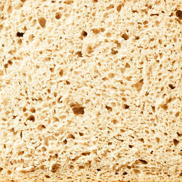 炭水化物 穀物又は穀物のための食品又は栄養の概念におけるスライスされた新鮮なパンの完全なフレーム正方形の形式の背景のテクスチャ — ストック写真