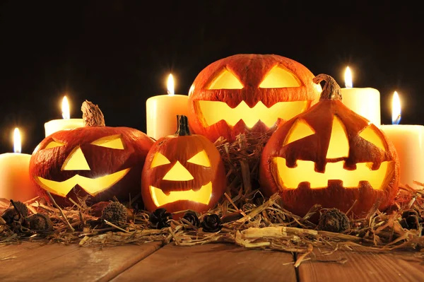 Three Lit Halloween Pumpkins Straw Old Weathered Wooden Boards Front — Stock Photo, Image