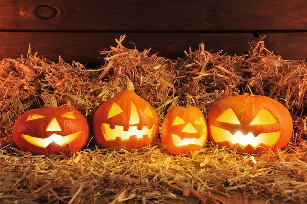 Four Lit Halloween Pumpkins Straw Old Weathered Wooden Boards Red — Φωτογραφία Αρχείου
