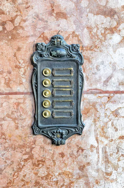 Old Wrought Iron Door Bell Sign Labels Marble Stone Background Stock Image