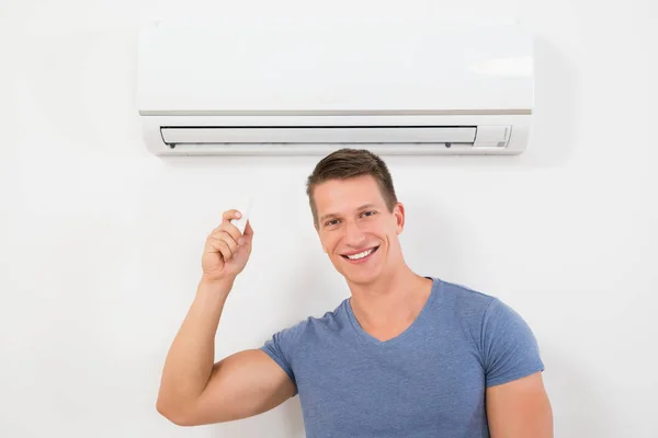 Portrait Happy Man Using Remote Control Operate Air Conditioner — Stock Photo, Image