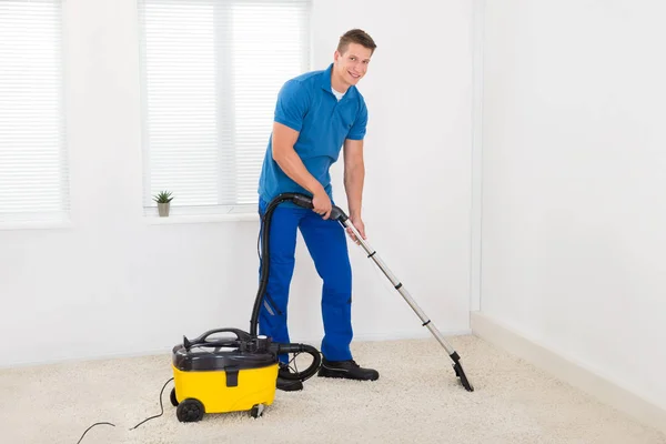 Happy Male Janitor Cleaning Carpet Vacuum Cleaner — Stock Photo, Image