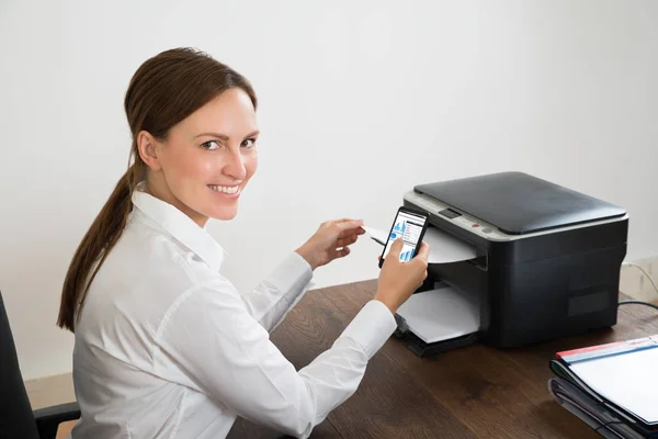 Young Happy Businesswoman Using Mobile Phone Printing Graph Paper — Stock Photo, Image