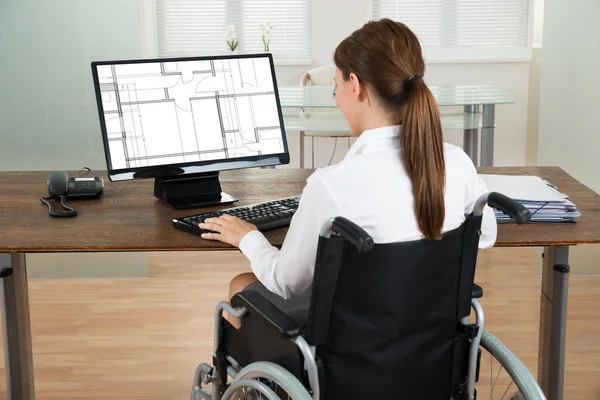 Young Female Architect Wheelchair Looking Blueprint Computer Office — Stock Photo, Image