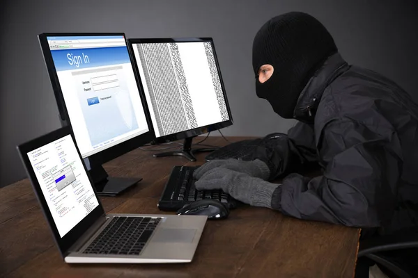 Hacker Wearing Balaclava Hacking Computers Desk — Fotografia de Stock