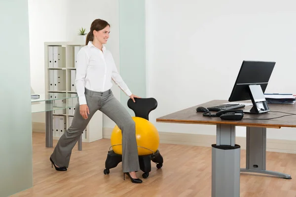 Young Happy Businesswoman Exercising Pilates Ball Chair Office Royalty Free Stock Photos