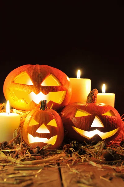 Three Lit Halloween Pumpkins Straw Old Weathered Wooden Boards Front — Stock Photo, Image