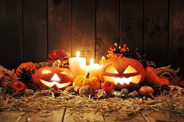 Illuminated Halloween Pumpkins Candles Nuts Corn Cob Apple Straw Front — Φωτογραφία Αρχείου