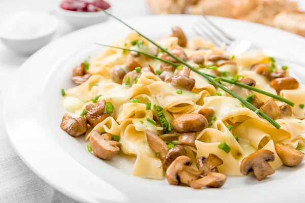 mushrooms with pasta,sauce and fresh chives