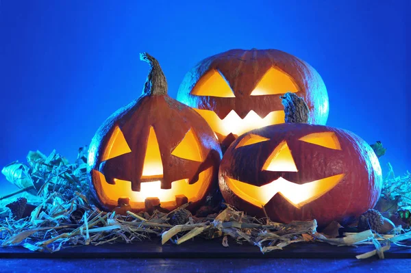 Three Blue Lit Halloween Pumpkins Straw Old Weathered Wooden Boards — Stock Photo, Image
