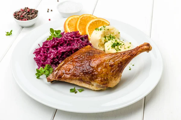 roast duck with dumplings,red cabbage and oranges
