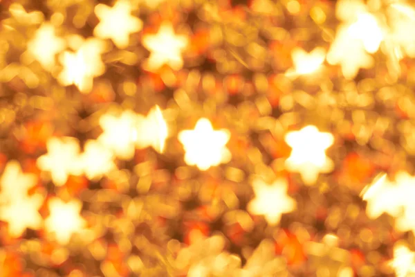 Kerst Achtergrond Met Wazig Gouden Sterren Een Rode Achtergrond — Stockfoto