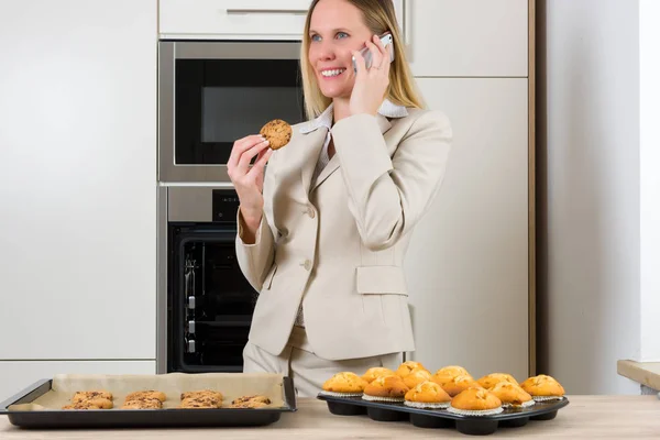 young woman in kitchen with a cake