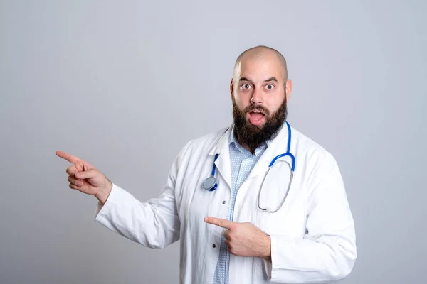Young Bearded Doctor White Coat Looking Amazed Pointing Side — Stock Photo, Image