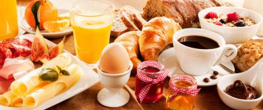 Breakfast feast with egg, meat, bread, coffee and juice clipart