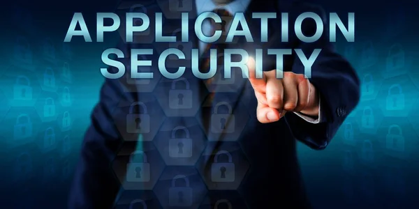 Executive user pushing APPLICATION SECURITY onscreen. Business and technology concept for security policy of a software application, the prevention of flaws in its design and securing of a network.