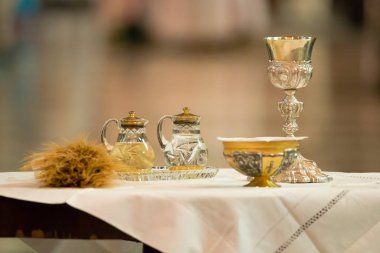 Goblet and ampoules for the offertory of the Communion during the Mass clipart