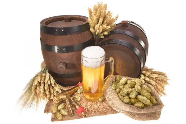 beer glass and two beer barrels with wheat,barley,hops,malt isolated on white\n