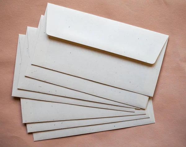 Letter envelopes for mail postage over orange paper background