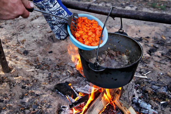 Outdoor cooking. Making food on a fire in a pot