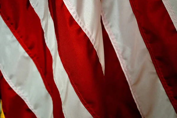 Red stripe patriotic holiday background of the american flag, closeup. Emblem of freedom and democracy. red stripes  of the flag of the United States of America.