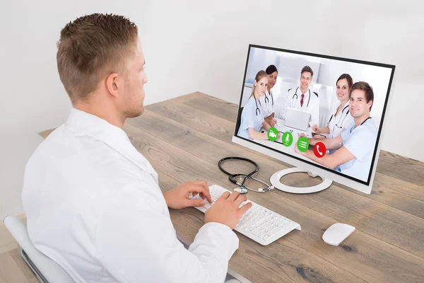 Young Male Doctor Video Conferencing Medical Team Computer Desk Clinic Royalty Free Stock Images