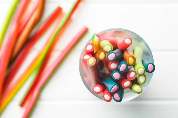 Sweet Gummy Sticks Different Flavor Top View Tasty Candy Glass — Stock Photo, Image