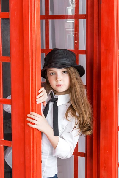 Little Girl Looks Out Phone Booth Closeup — Stock Photo, Image
