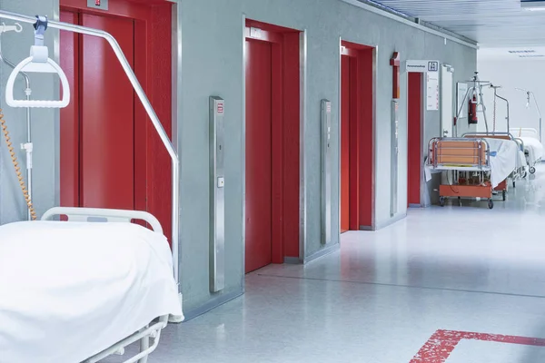 hallway in the hospital with two beds lift red
