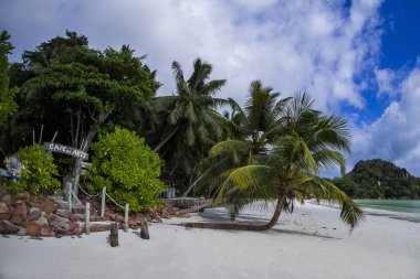 praslin in the seychelles at anse volbert / cote d'or beach clipart