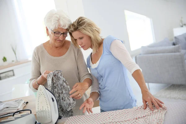 Elderly Woman Housekeeper Ironing Clothes — Stock Photo, Image