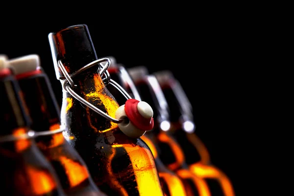 Row Glowing Beer Bottles Stoppers Darkness Selective Focus Opened Stopper — Stock Photo, Image
