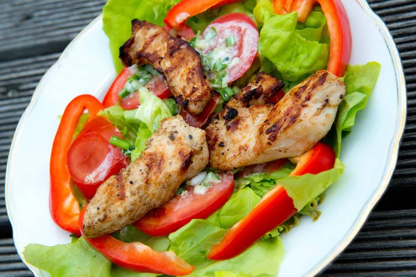fresh salad with chicken filet and white dressing