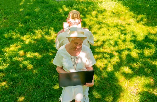 Happy Old Couple Sitting Green Grass Park Grandfather Reading Book — Stock Photo, Image