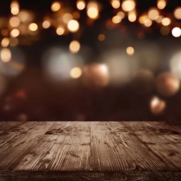 dark abstract background with christmas lights in front of a table