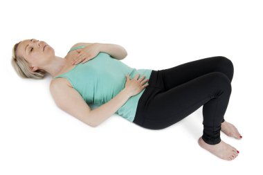 young woman hands placed supine on a white background with attached squat legs,eyes closed on the stomach and chest. clipart