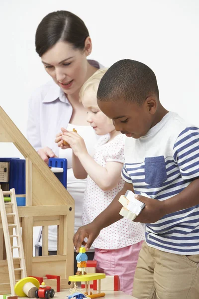 Pre School Teacher Pupils Playing Wooden House — Stock Photo, Image