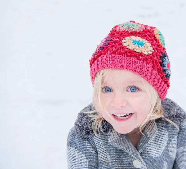 Happy toddler with colourful beanie