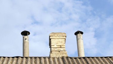 photographed pipe and chimney brick chimney of a private house clipart