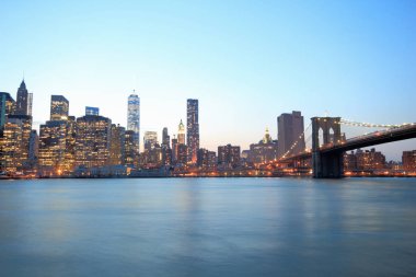 Lower Manhattan skyline and Brooklyn Bridge at dusk, New York, USA clipart