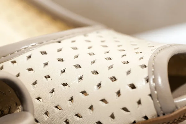 summer photographed close-up women shoes beige and with holes for ventilation, a small depth of field